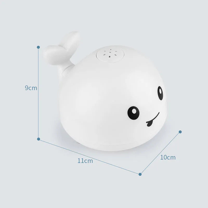 Whale-shaped electric bath toy spraying water with flashing lights, on a blue base.