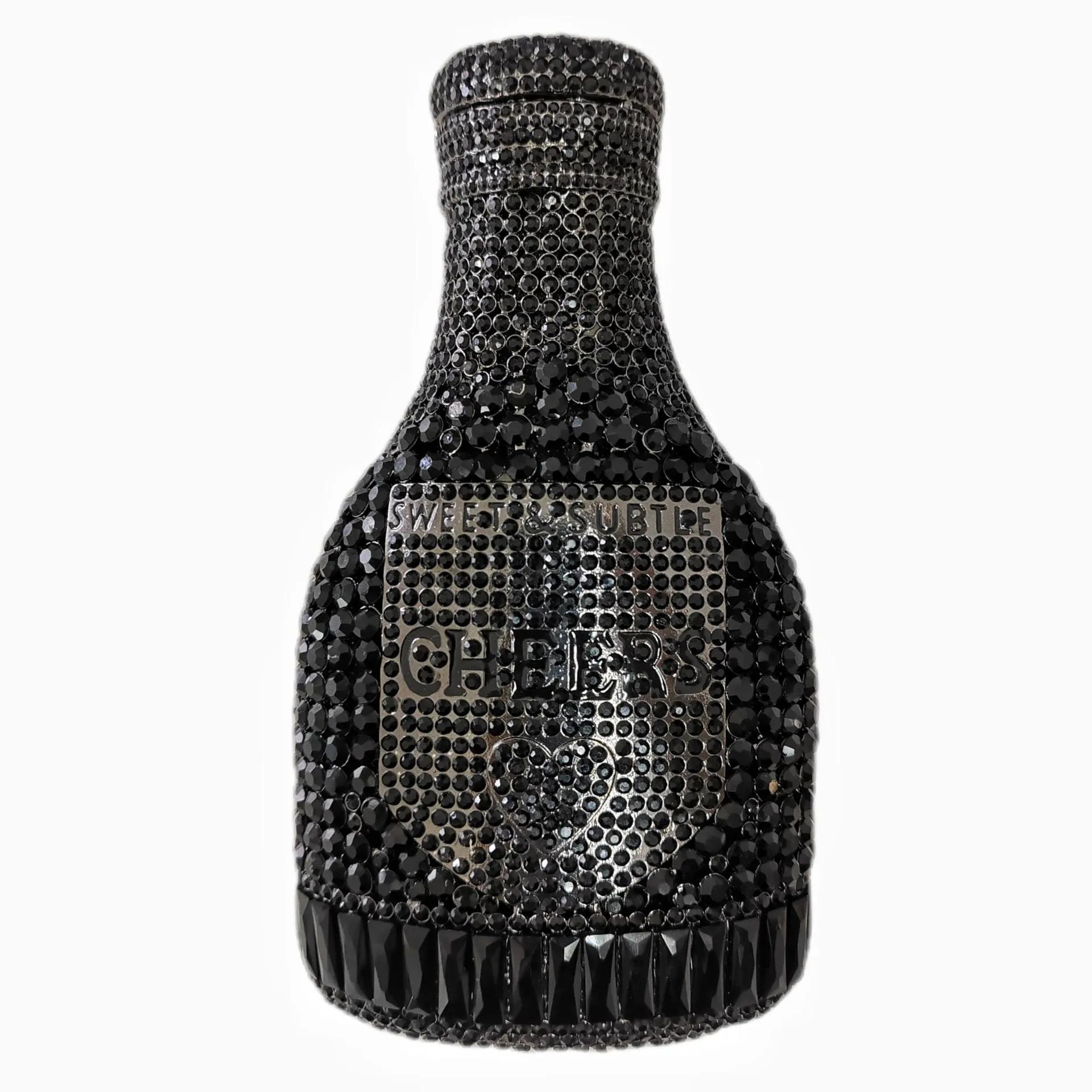 Gold hard-shell champagne bottle shaped evening clutch with rhinestones on a table.