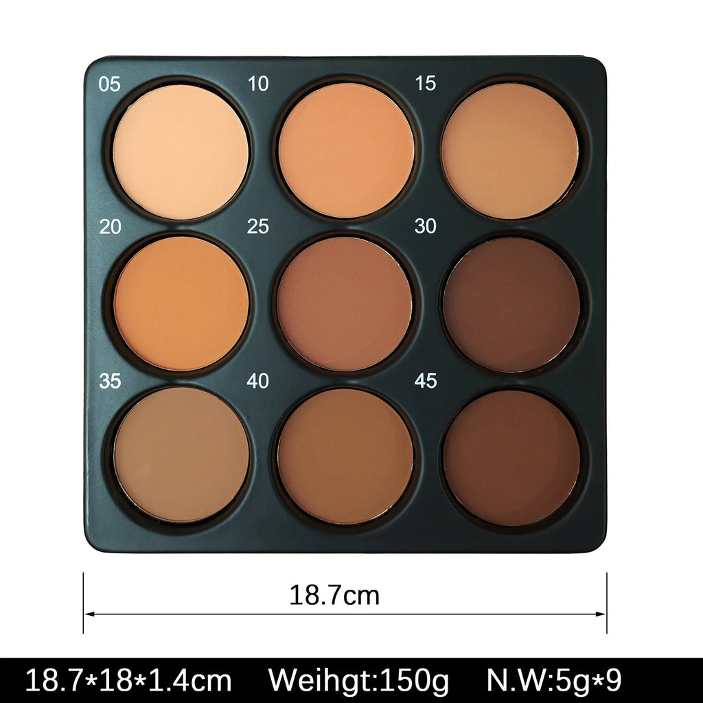 Open dark matte eyeshadow palette showing nine dark coloured pans with a repair disk.