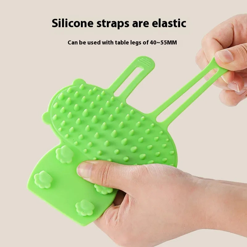 Silicone pet grooming massage comb with rounded teeth and adjustable strap for table leg mounting