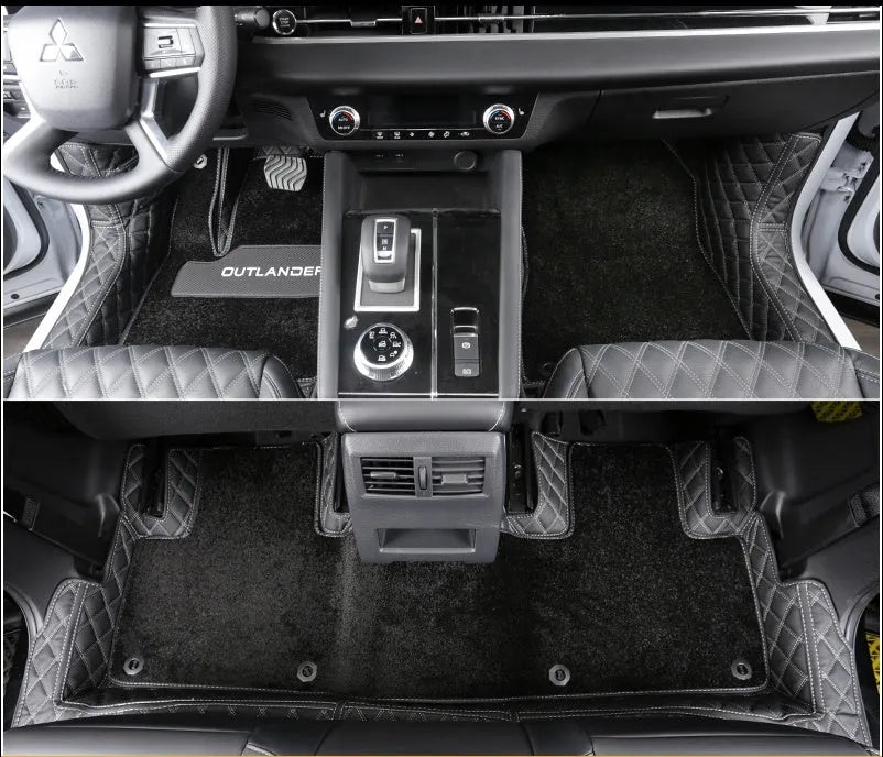 Custom black PU floor mats fitted in a Mitsubishi Outlander footwell.