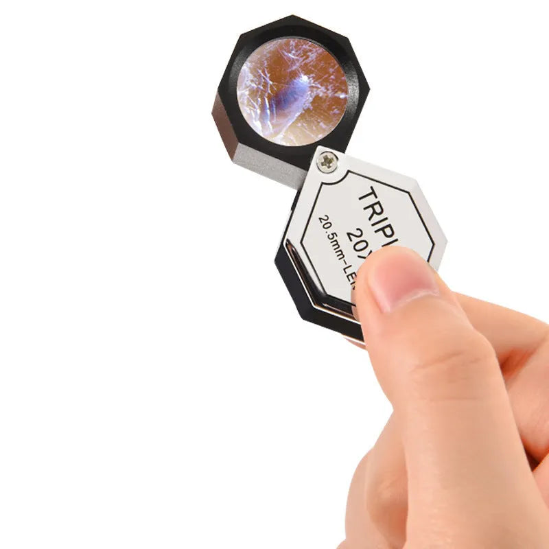 Handheld portable magnifying glass with metal body for jewellery and coin inspection