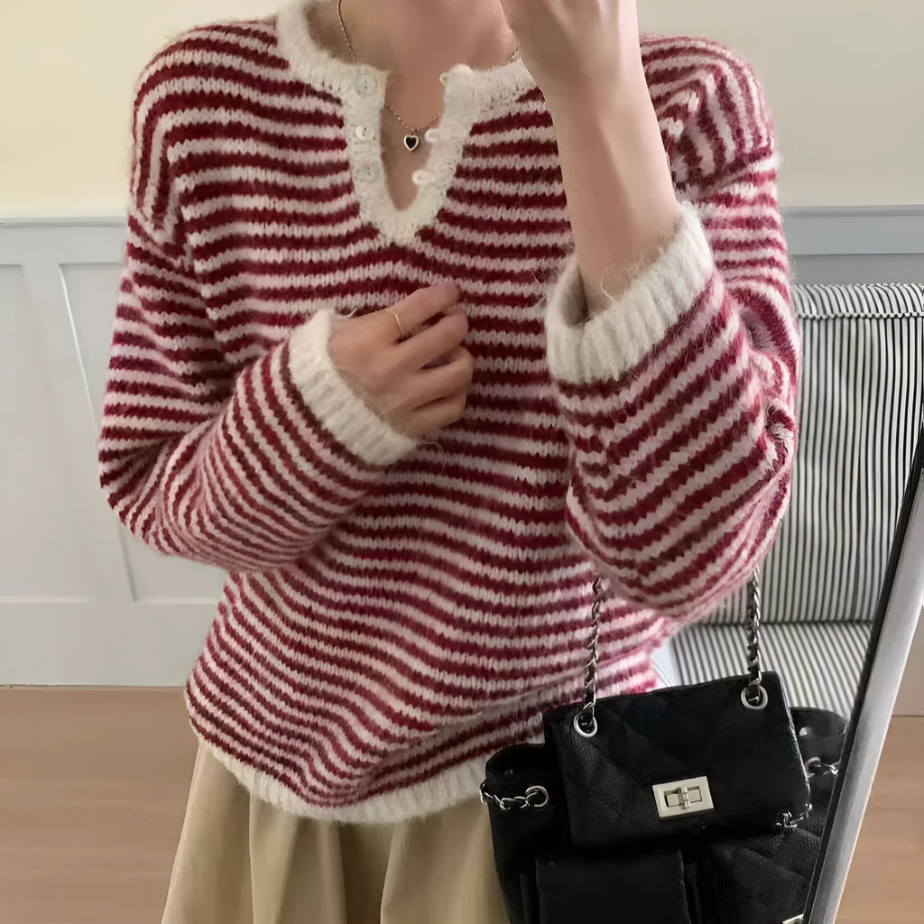 Red and blue striped women's cashmere pullover sweater on a hanger.