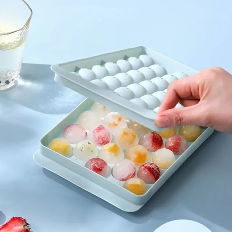 Blue silicone ice cube tray with lid showing 33 round grids for homemade ice making