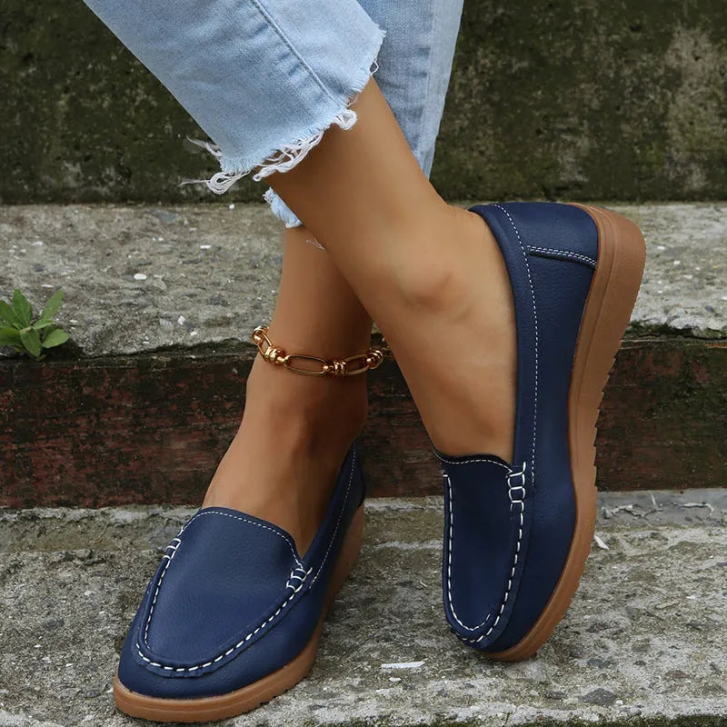 Women's flat slip-on loafers in PU leather, showing round toe and available colour options