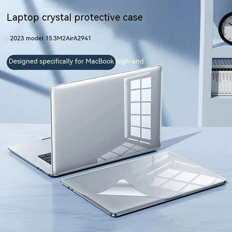 Hard plastic protective case fitted on a silver MacBook Pro laptop, showing clear transparent finish.