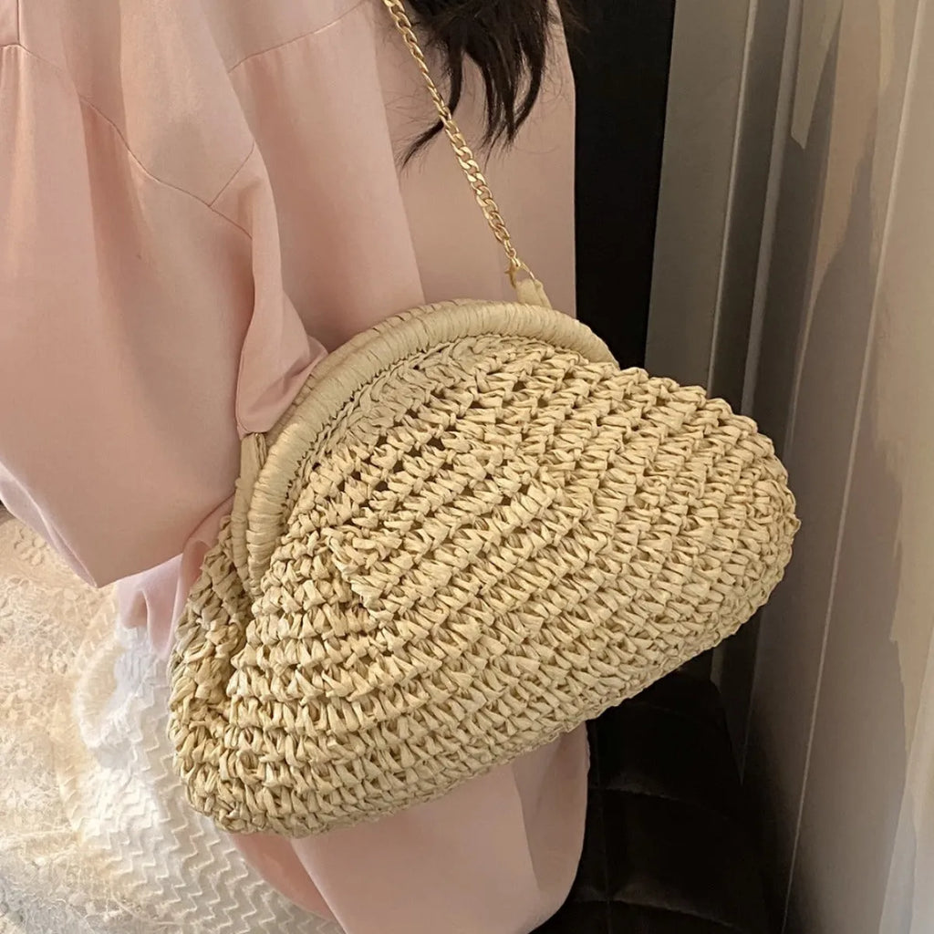 Shell-shaped women's straw bag with chain strap in khaki colour option showing zippered pocket detail