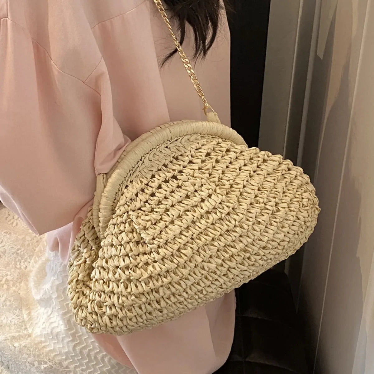 Shell-shaped women's straw bag with chain strap in khaki colour option showing zippered pocket detail