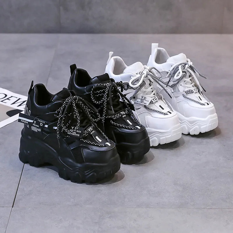 White women's mesh platform tennis shoes with cross strap and a thick rubber sole.