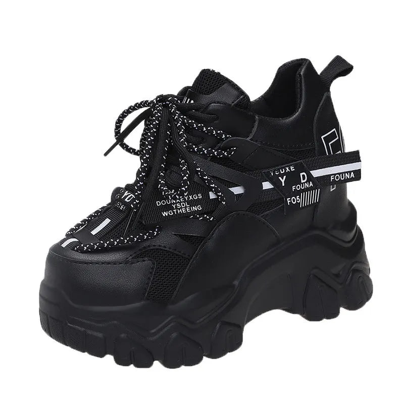 White women's mesh platform tennis shoes with cross strap and a thick rubber sole.