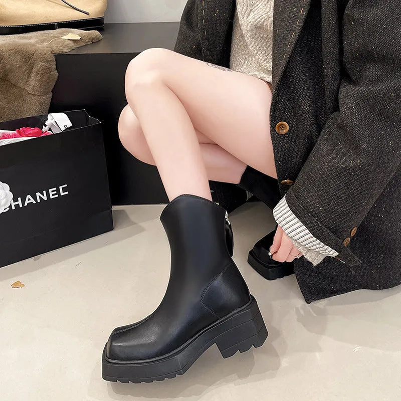 Black platform Martin ankle boots for women with a square toe and back zipper.