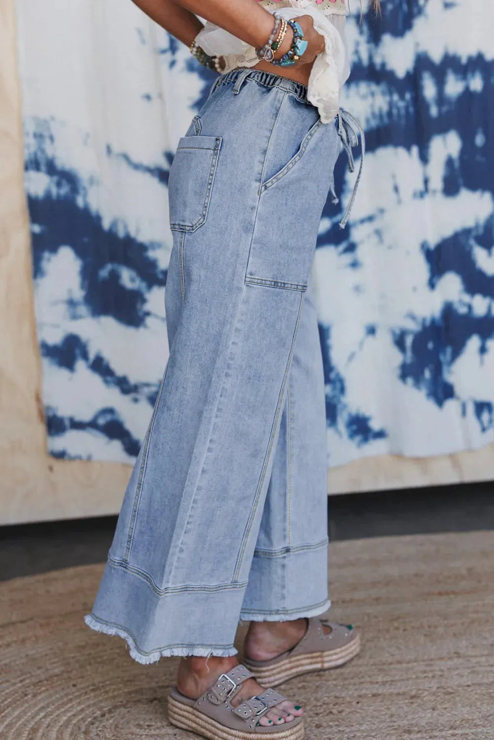 Beau Blue women's wide leg denim trousers with drawstring waist and raw hem.