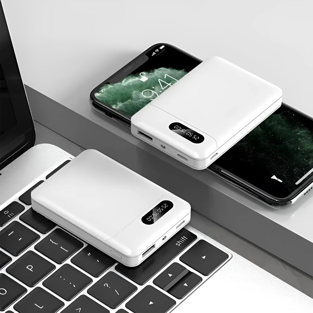White or black large capacity portable power bank with multiple USB ports, shown next to a smartphone.