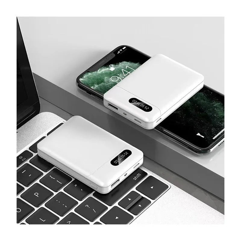 White or black large capacity portable power bank with multiple USB ports, shown next to a smartphone.