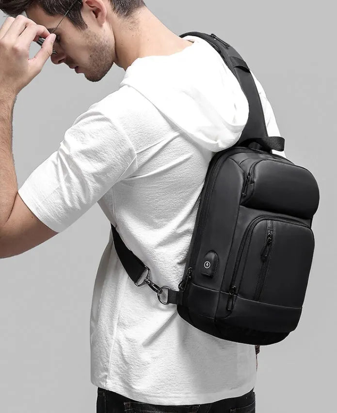 Black outdoor shoulder bag showing internal computer pocket and air cushion shoulder strap