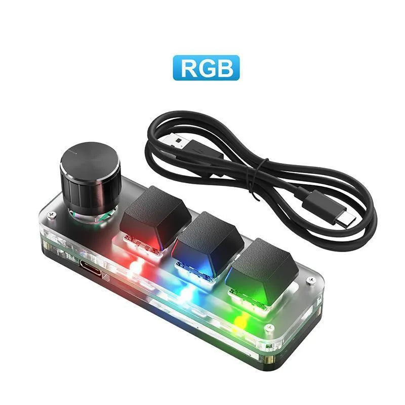 Black programmable mini keyboard with RGB backlit keys showing copy and paste shortcuts