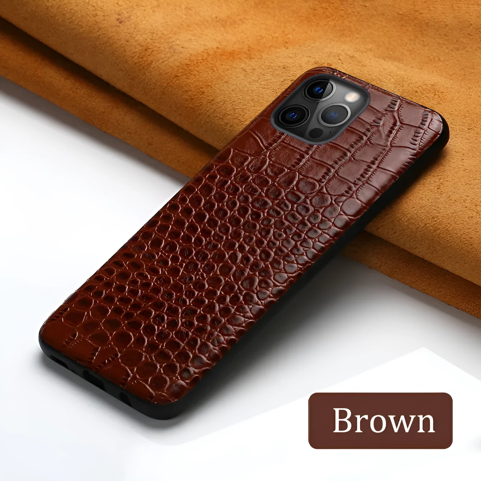 Black leather iPhone case with a crocodile pattern texture lying flat.