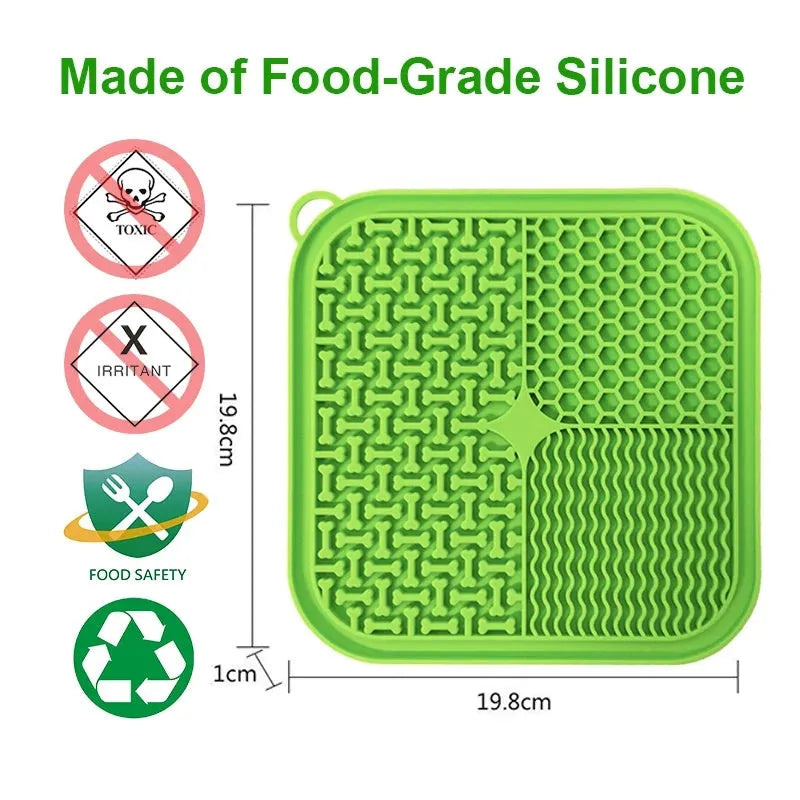 Blue silicone dog lick mat with textured surface and suction cups on back, shown on a tiled floor.