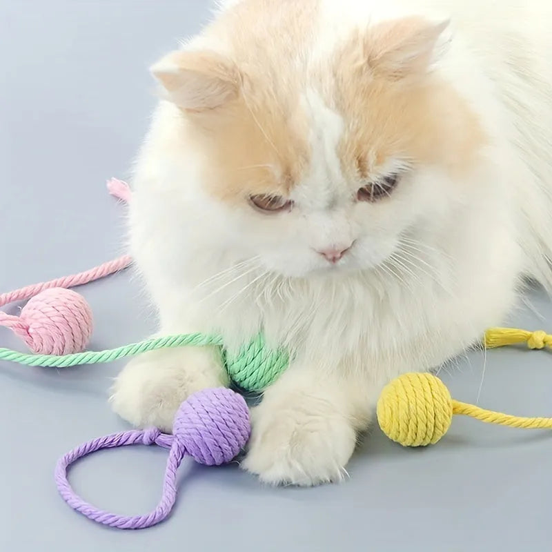 Green and pink soft plush cat toy balls with rope tails and internal bells
