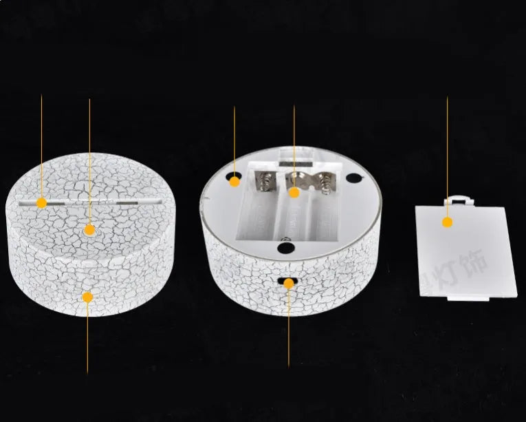 3D acrylic LED table lamp with remote control on a desk, showing colourful illumination.