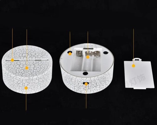 3D acrylic LED table lamp with remote control on a desk, showing colourful illumination.