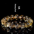 Natural yellow citrine gemstone bead bracelet showing geometrical beads on a string.