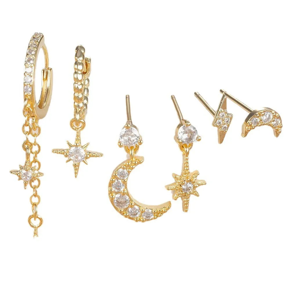 Six pairs of gold chain tassel earrings with zircon studs displayed together