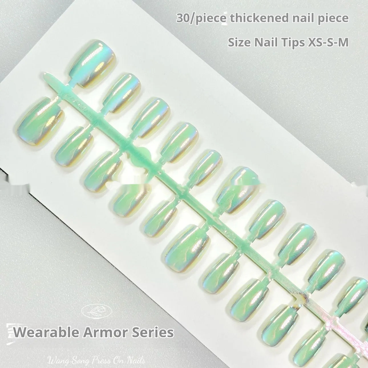 Electroplated cat's eye false nails with aurora colours in short ladder lengths on a hand.