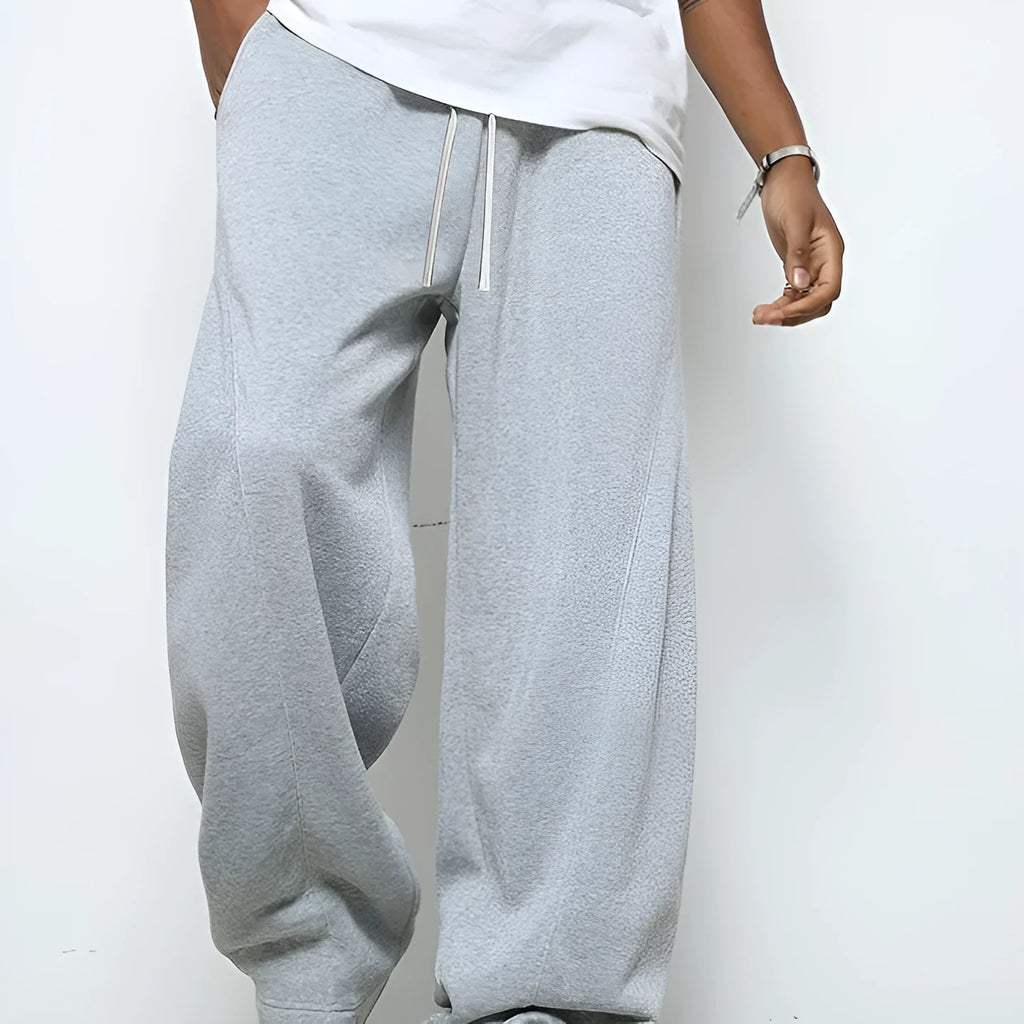 Men's straight-leg casual trousers in black with a micro-elastic waistband and drawstring closure.