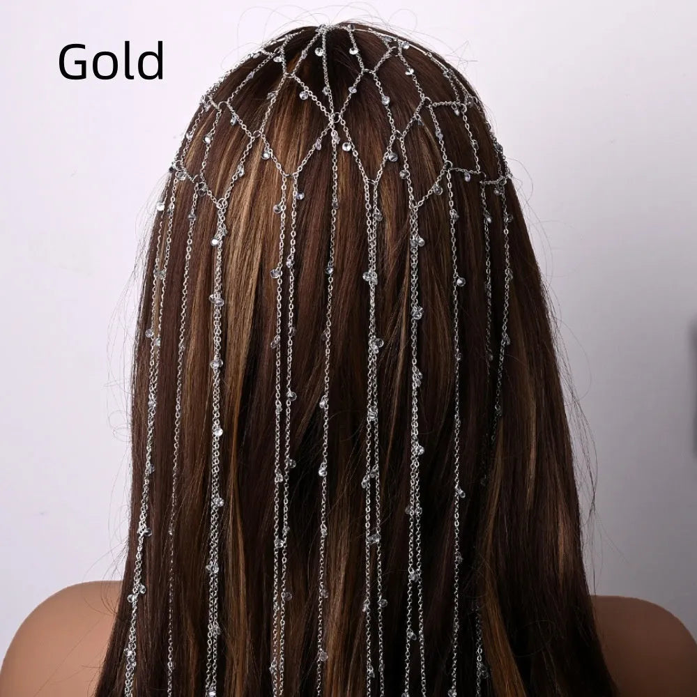Gold and silver rhinestone mesh headband with a decorative tassel accessory.