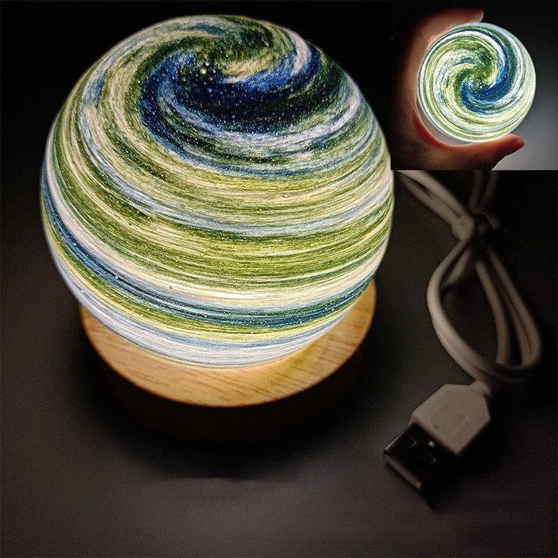 Compact modern planet USB night light on its base with dimmable three-colour lighting.