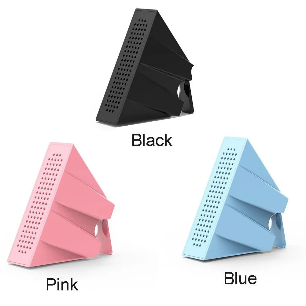 A portable black ABS plastic phone amplifier holder on a desktop, showing a mobile phone inserted for sound amplification.