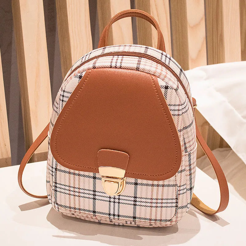 A black one shoulder diagonal phone bag made from PU fabric, shown being worn.