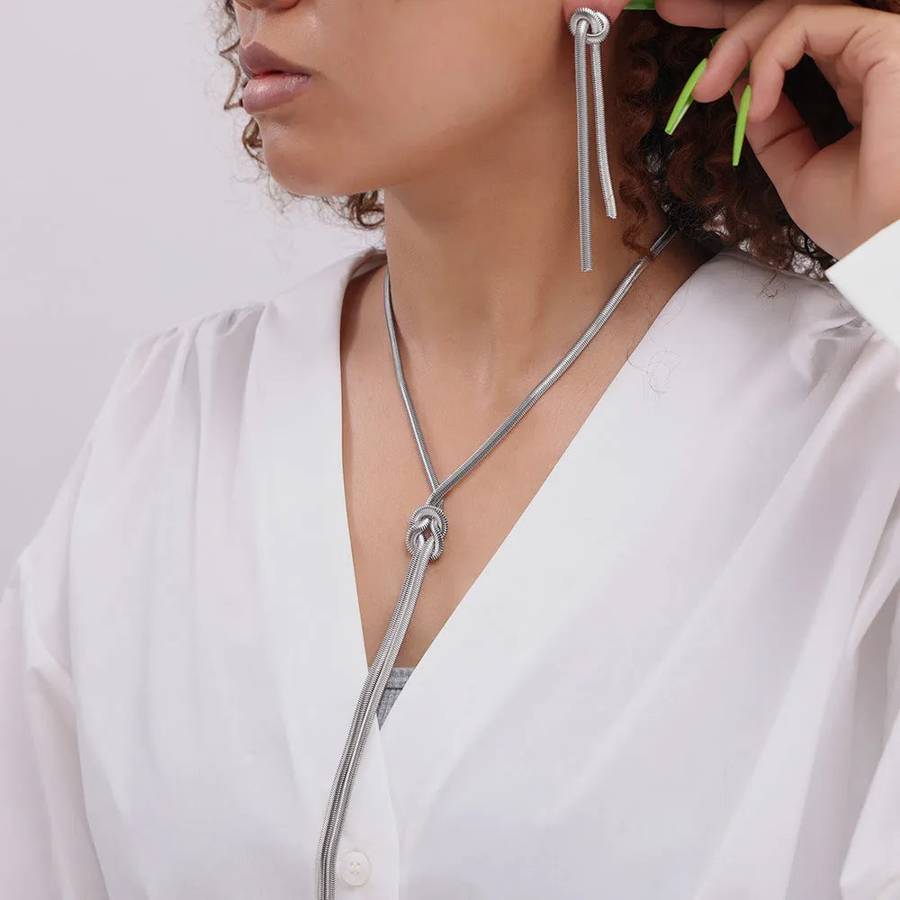 Gold electroplated titanium steel necklace and earrings set with snake chain and knotted tassel design
