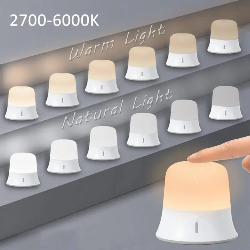 White rechargeable touch control night light with dimmer and motion sensor on a bedside table.