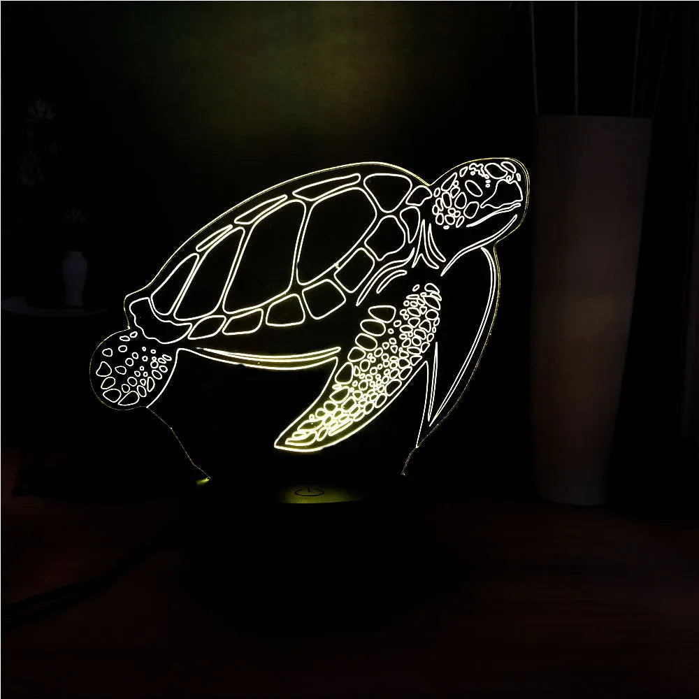 3D acrylic turtle-shaped LED night light with colour-changing modes on a table.