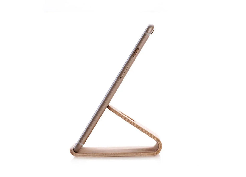 Walnut wooden iPhone stand with lazy bracket design on wooden desk