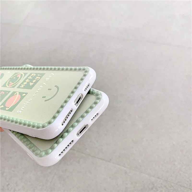 Green TPU iPhone case with polka dot frame and smiley face design on the back.