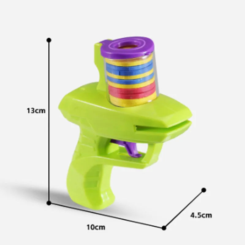 Interactive cat toy launcher firing foam disc with green plastic construction