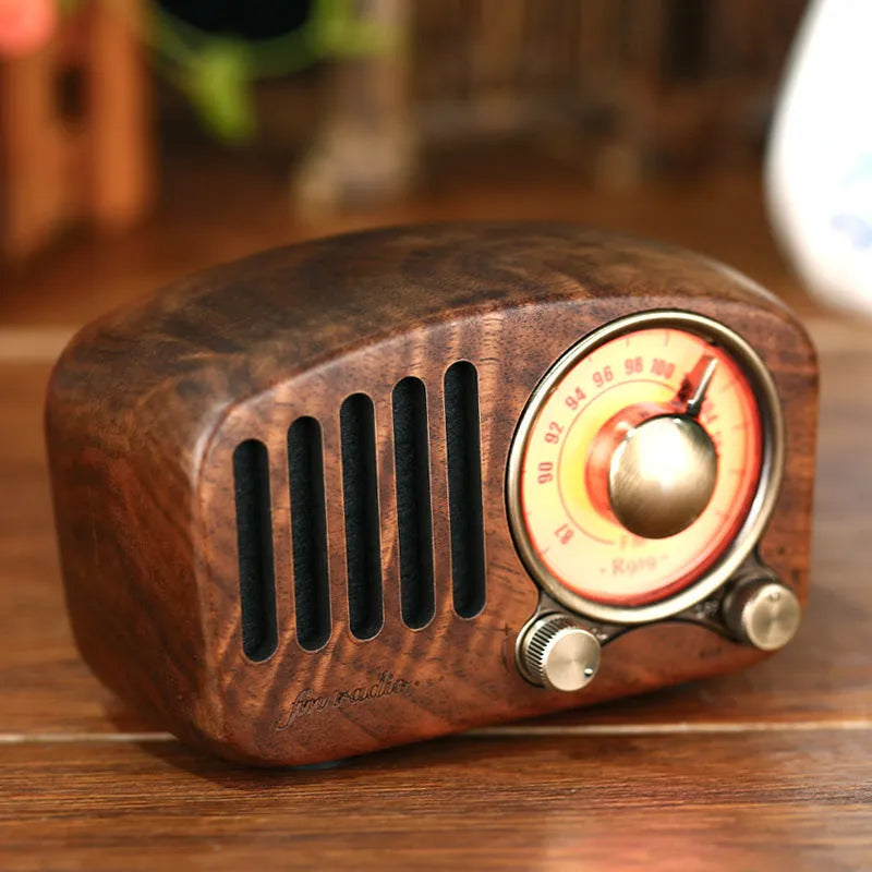 Retro wooden wireless mini speaker in cherry wood finish showing front and side.