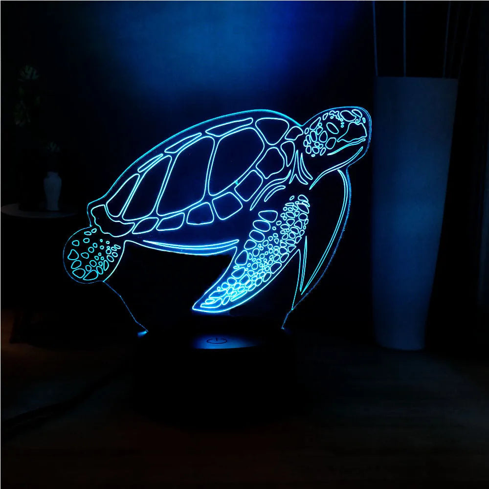3D acrylic turtle-shaped LED night light with colour-changing modes on a table.