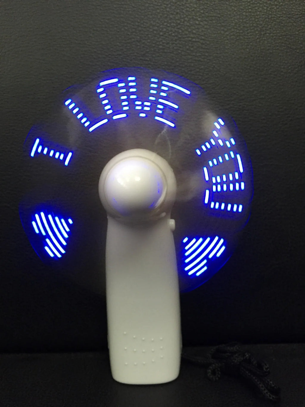 White handheld fan with LED flashing I love you pattern in blue and red colours