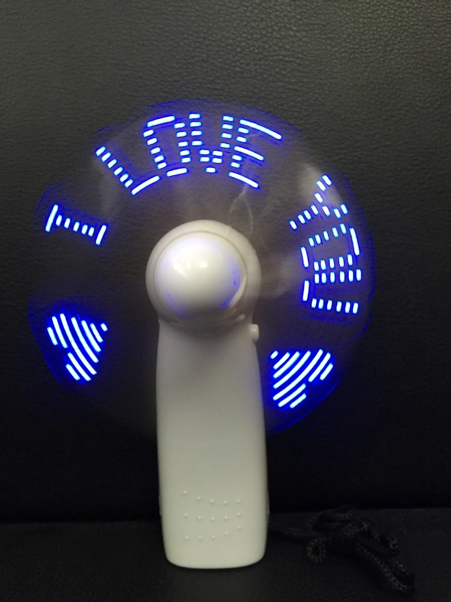 White handheld fan with LED flashing I love you pattern in blue and red colours
