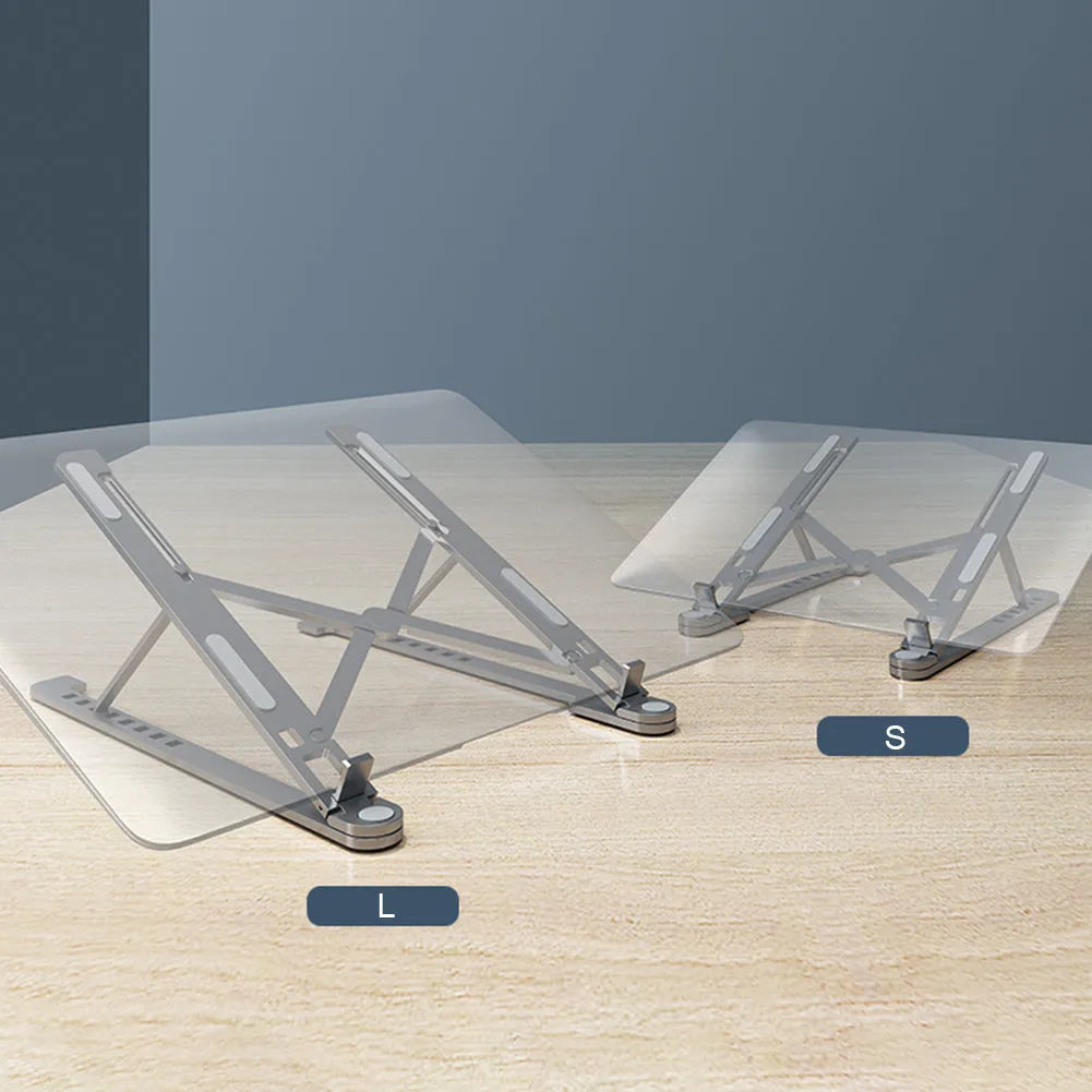 A folded aluminium laptop stand in silver next to an open laptop, demonstrating its compact size.