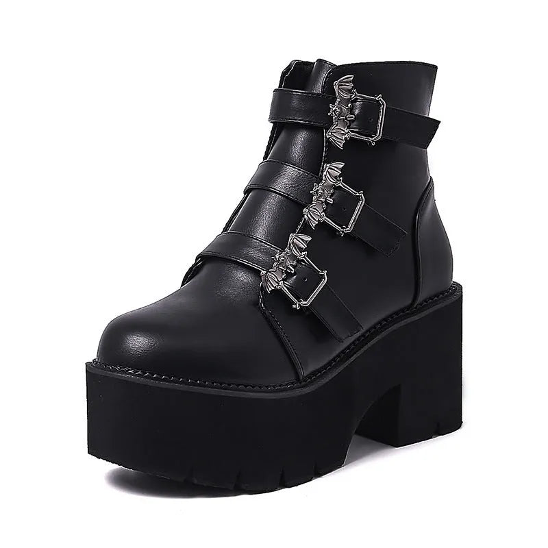 Black women's punk style ankle boots with bat buckle and side zip.