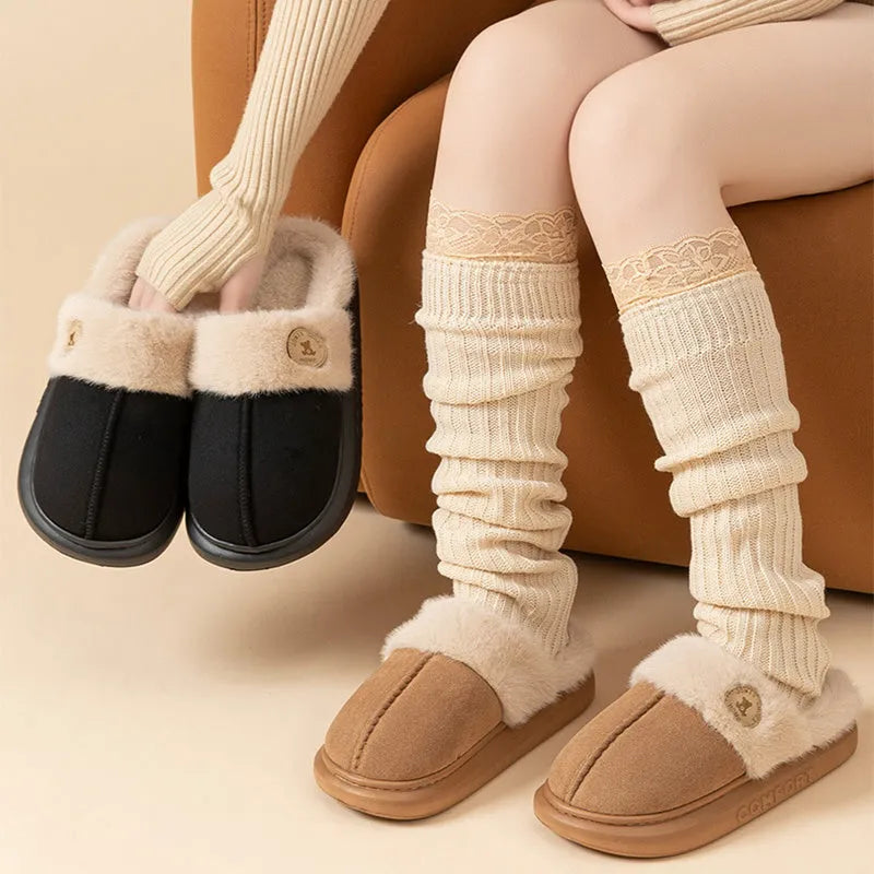 Fleece indoor slippers with thick PVC soles in various colours showing car stitching detail