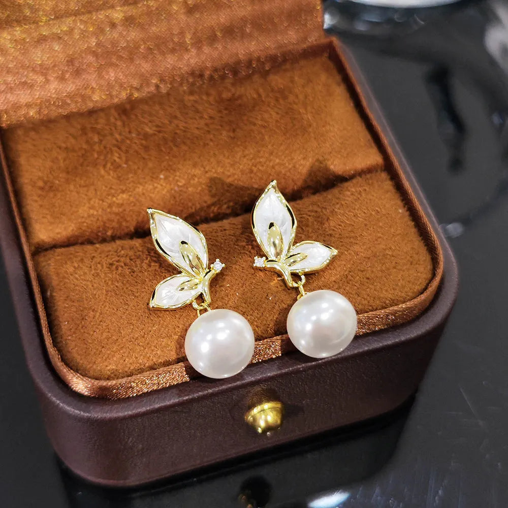 Gold-tone butterfly earrings with zircon painting detail on copper wings