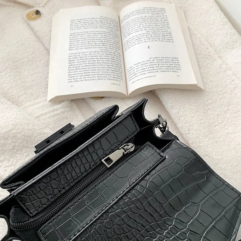 Vintage style crossbody bag in PU leather, shown in black, dimensions 20cm by 14cm.