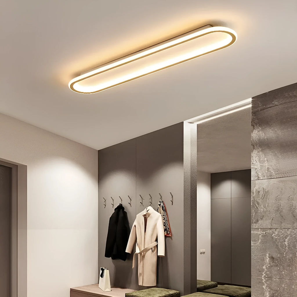 Minimalist black strip ceiling lamp with aluminium body and PVC shade mounted on a white ceiling.