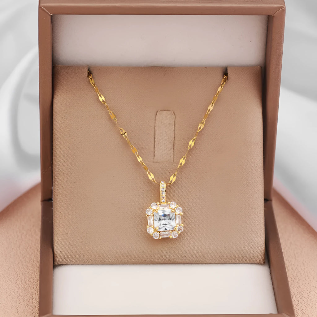 Gold tone geometric quadrilateral pendant necklace with inlaid zircon stones on a water wave chain.